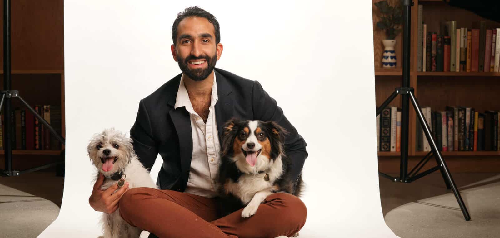 Manick Bhan with two dogs during speaking engagement presentation.