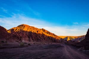 Breathtaking desert landscape with colorful mountains at sunset.