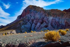 Colorful mountain landscape with vibrant rock formations and clear blue sky.